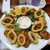 Calamares fritos on salad with plantain and garlic mayo