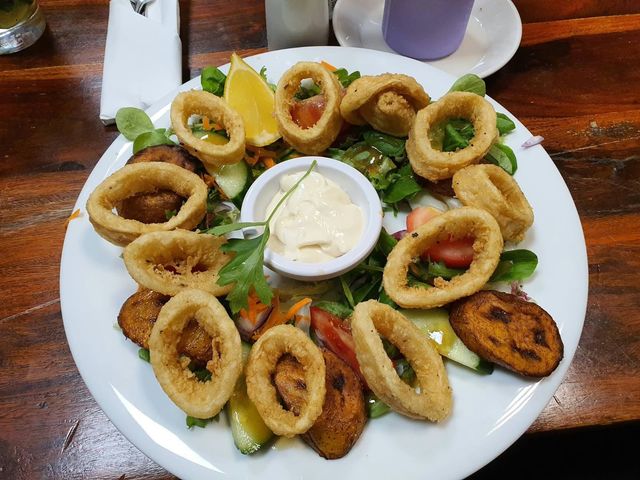 Calamares fritos on salad with plantain and garlic mayo