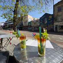 Two mojitos on a café table on Stokes Croft